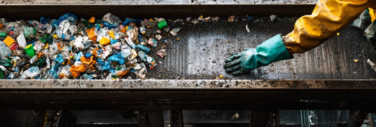 Ein Fließband voll Müll in einer Recycling-Firma